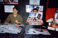 [Paul Dini and Chip Kidd signing Batman Animated (Product Image)]